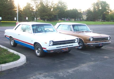 1979 Ford F-150 - Two 1967 Rambler American cars are parked side-by-side in an outdoor lot.