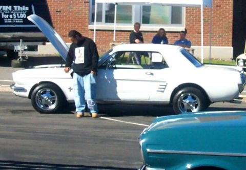 1979 Ford F-150 - A white coupe is parked with its hood open, while a person stands nearby.