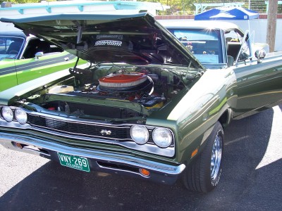1972 Ford Ranchero - A green 1969 Dodge Super Bee is displayed with its hood open, revealing the engine bay.