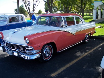 1972 Ford Ranchero - A two-tone red and white 1955 sedan is parked next to a blue pickup truck.