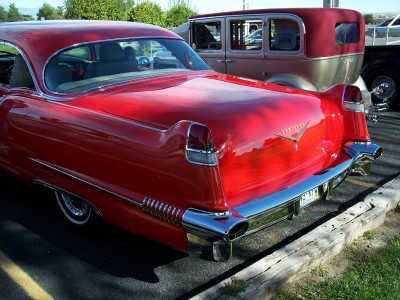 1972 Ford Ranchero - Rear view of a shiny red classic car parked next to another vintage vehicle.