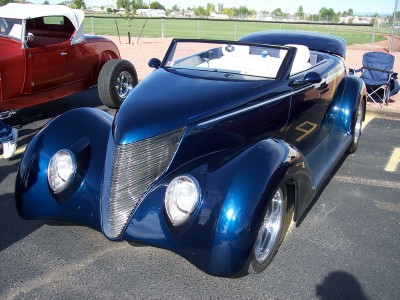 1972 Ford Ranchero - A blue custom convertible hot rod is parked next to another hot rod at an outdoor event.