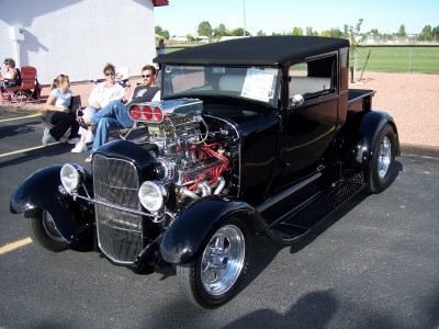 1972 Ford Ranchero - This heavily modified pickup truck features a prominent exposed engine with a blower, a common modification for hot rods.