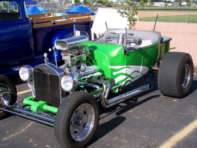 1972 Ford Ranchero - A heavily modified hot rod, likely a T-bucket, with a prominent V8 engine and custom paint.