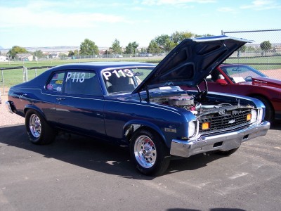 1972 Ford Ranchero - This blue 1973 Chevrolet Nova coupe has its hood open, revealing the engine, and displays 'P113' on its windows.