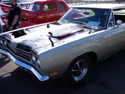 1972 Ford Ranchero - A white 1970 Plymouth Duster is parked in front of a red vehicle.