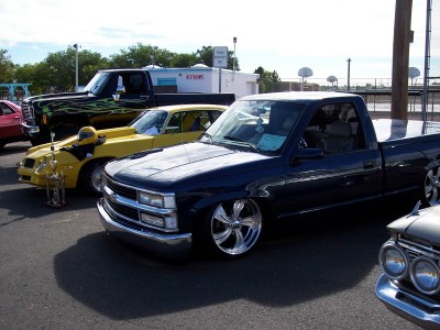 1972 Ford Ranchero - A dark blue pickup truck with a white hood is parked in a lot with other vehicles visible.