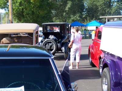 1972 Ford Ranchero - A collection of antique automobiles are on display at an outdoor event, with people milling around.