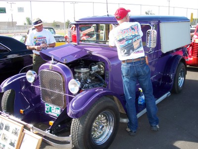 1972 Ford Ranchero - A purple panel van is displayed with its hood open, revealing the engine. The license plate indicates '27 GRAN'.