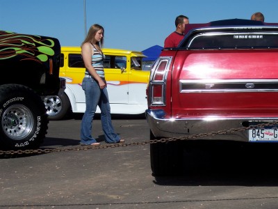 1972 Ford Ranchero - A red 1972 Ford Ranchero is parked next to other vehicles under a clear blue sky.