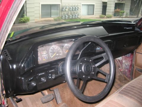 1991 Ford Bronco - The interior of a vehicle shows the dashboard, steering wheel, and instrument cluster.