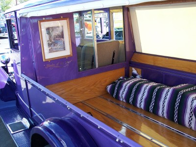 1972 Ford Ranchero - The interior of a purple pickup truck bed shows off its wooden floor and a striped blanket.