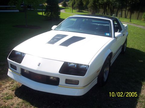 1988 Chevrolet Camaro - Front 3/4 view of a white 1988 Chevrolet Camaro with distinctive hood louvers and a black roof.