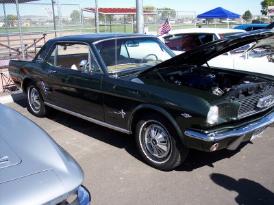 1972 Ford Ranchero - A classic Ford Mustang is displayed with its hood up at an outdoor event.