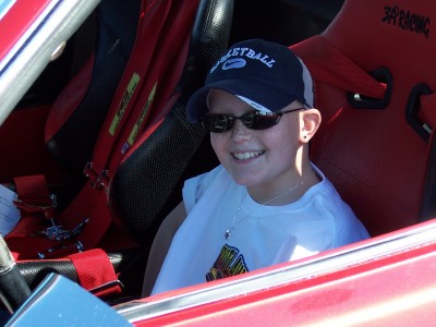 1972 Ford Ranchero - Child in a racing seat, wearing a cap and sunglasses.