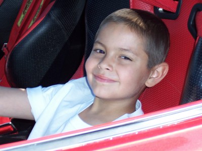 1972 Ford Ranchero - A young boy smiles while sitting in a vehicle's interior, which appears to be a racing seat.