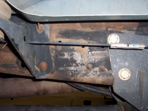 1996 Ford Bronco - Close-up view of the undercarriage of a vehicle, showing frame components and a wiring harness.