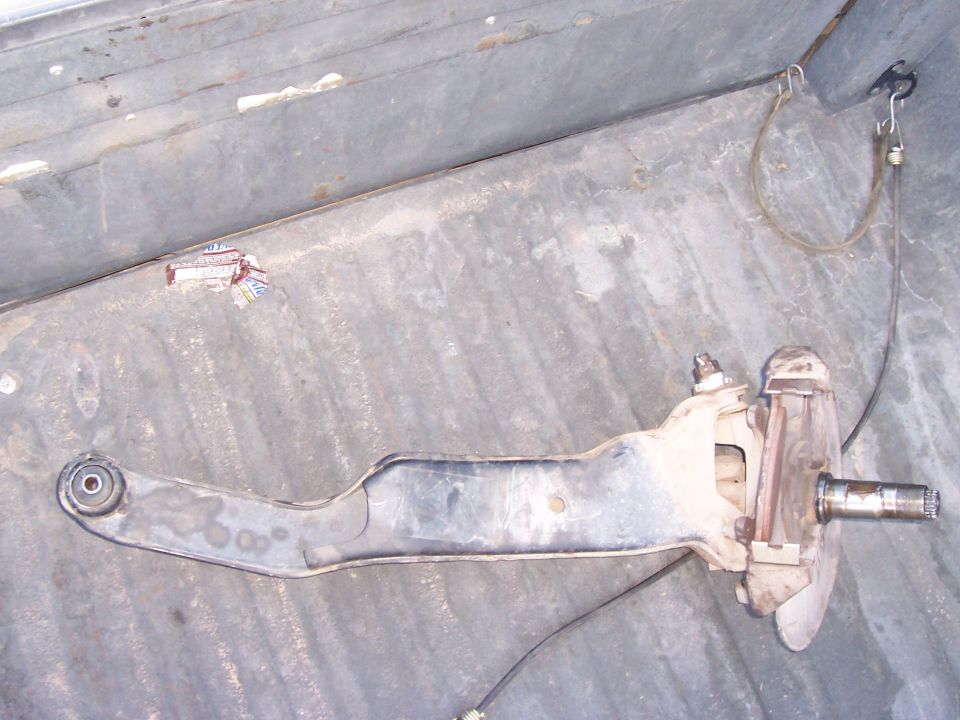 Front suspension control arm and spindle assembly, possibly from a truck or SUV