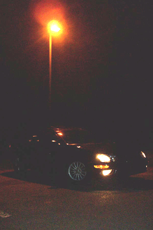 1999 Chrysler 300M - A 1999 Chrysler 300M is parked at night, illuminated by a streetlamp.