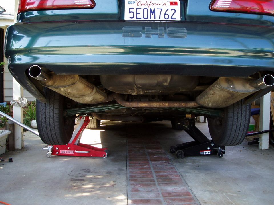 1993 Ford Taurus SHO rear exhaust system with dual mufflers and tailpipes, jacked up for service