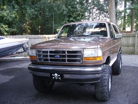 1993 Ford Bronco - This lifted 1993 Ford Bronco features large off-road tires and a custom skull and crossbones license plate frame.