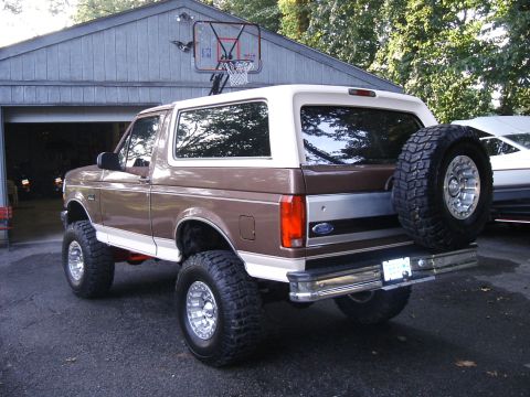 1993 Ford Bronco - Rear view of a lifted 1993 Ford Bronco with a spare tire mounted externally.