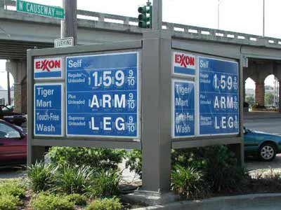 1990 Ford Bronco - Gas prices are displayed on an Exxon sign, with regular unleaded listed at $1.59 per gallon.