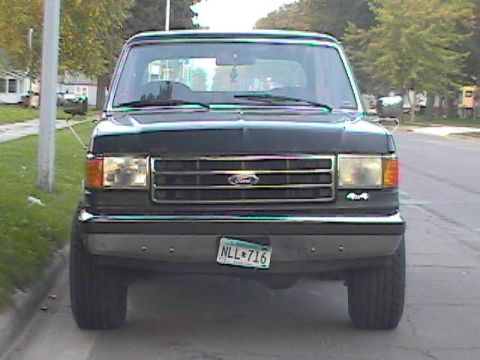 1989 Ford Bronco - This 1989 Ford Bronco is captured from a front-facing perspective, its iconic grille and headlights.