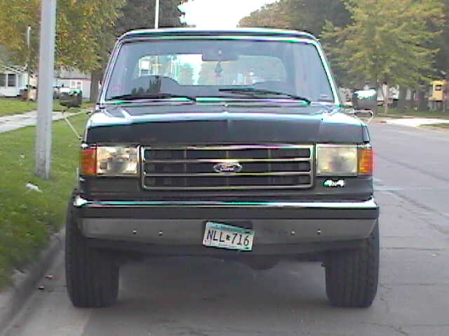 Front view of a black 1989 Ford Bronco with a license plate reading NLL 716