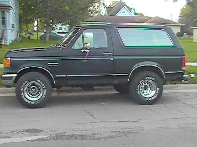 1989 Ford Bronco parked on street, side view