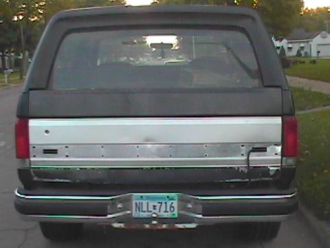 1989 Ford Bronco - The rear of a 1989 Ford Bronco is shown, a silver trim panel and a license plate.