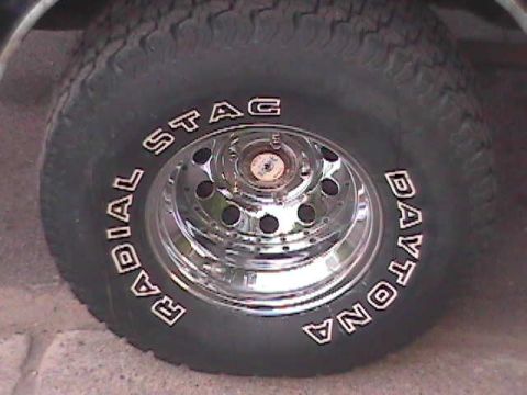 1989 Ford Bronco - Close-up of a Radial Stac Daytona tire mounted on a chrome wheel.