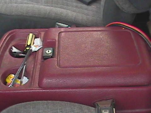 1989 Ford Bronco - Center console interior of a 1989 Ford Bronco, showing cup holders and tools.