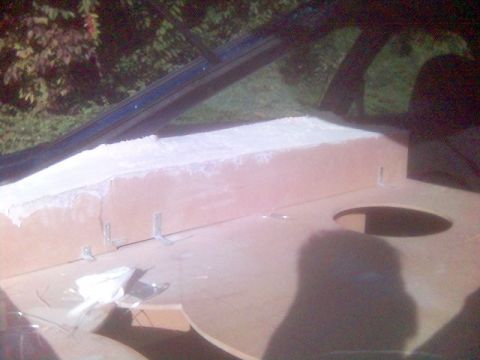 1994 Ford Probe - This image shows the interior of a vehicle with custom wooden paneling and filler material being applied.