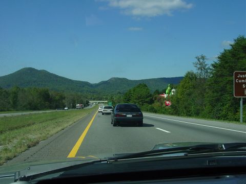1986 Ford Mustang - Driving a 1986 Ford Mustang on a highway with mountains visible.