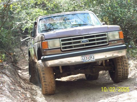 1987 Ford Bronco - This Ford truck is navigating a dirt path surrounded by trees, with a date stamp of 10/02/2005 visible.