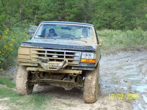 1987 Ford Bronco - This 1987 Ford Bronco navigates a muddy trail with a winch mounted on the front bumper.