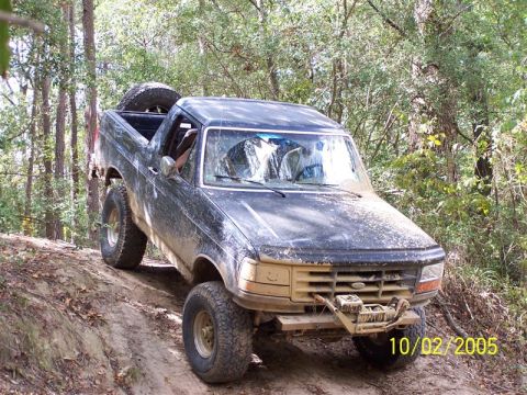 1987 Ford Bronco - A black Ford Bronco navigates a wooded trail on October 2, 2005.