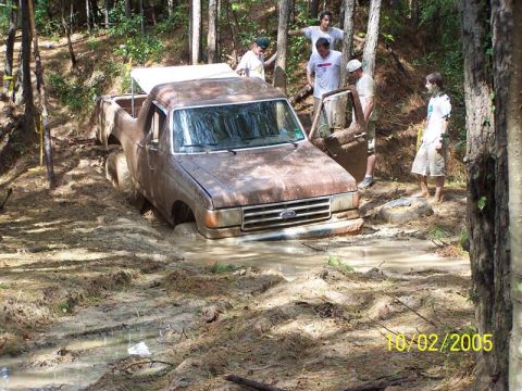 1987 Ford Bronco - Ford pickup stuck in mud with onlookers. The date 10/02/2005 is visible.