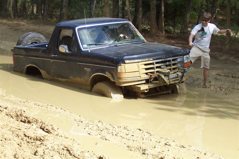1987 Ford Bronco stuck in mud with winch