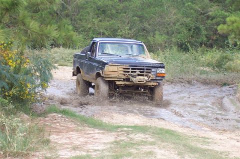 1987 Ford Bronco - This 1987 Ford Bronco is navigating a muddy off-road trail.