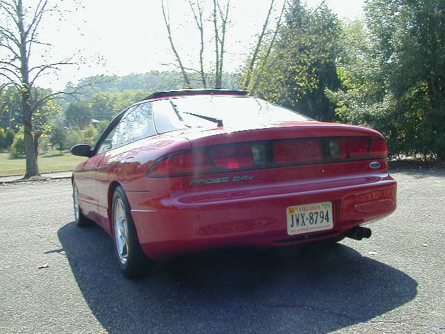 Red 1997 Ford Probe GT parked on asphalt, showing rear quarter view. Virginia license plate JWX-8794