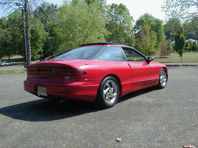 Red 1997 Ford Probe coupe from rear-right, parked on asphalt