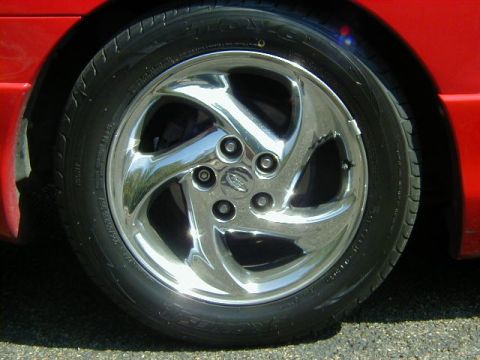 1997 Ford Probe - Close-up of a red car's wheel a chrome five-spoke rim and tire.