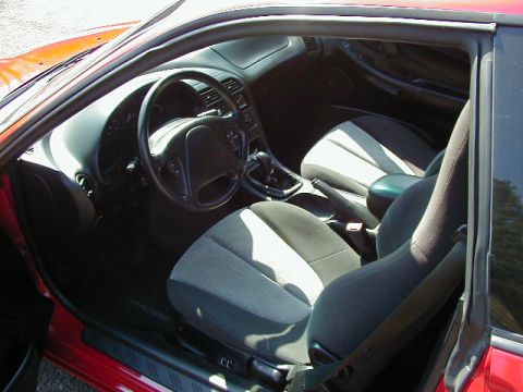 1997 Ford Probe - Interior view of a red car, showing the dashboard, steering wheel, and front seats.