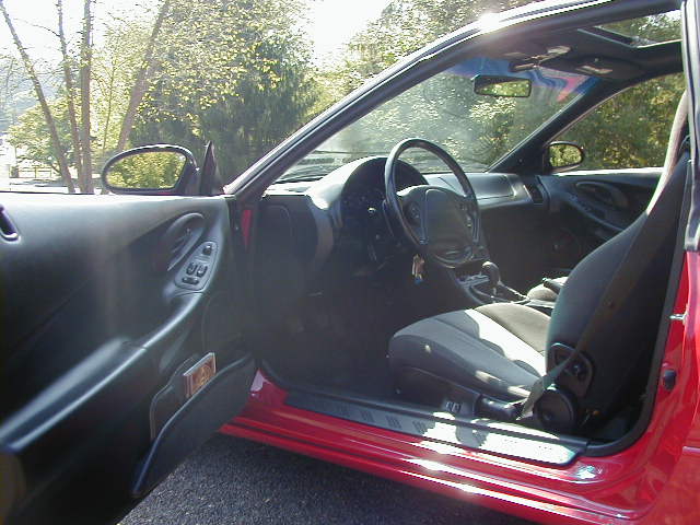 1997 Ford Probe interior showing driver's seat, dashboard, steering wheel, and door panel