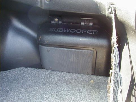 1997 Ford Probe - A black subwoofer enclosure is visible inside a vehicle's cargo area.