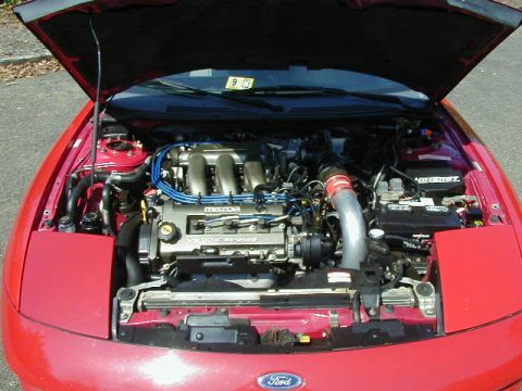 1997 Ford Probe - Engine bay of a 1997 Ford Probe GT, the V6 engine and front-mounted battery.
