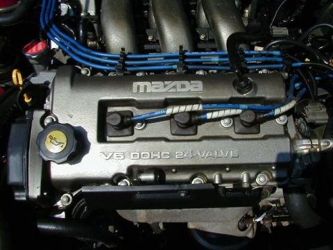 1997 Ford Probe - Close-up view of a Mazda V6 DOHC 24-valve engine, showing the valve cover and spark plug wires.