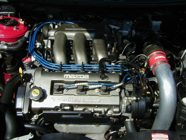 Mazda V6 DOHC 24-valve engine with red intake hose